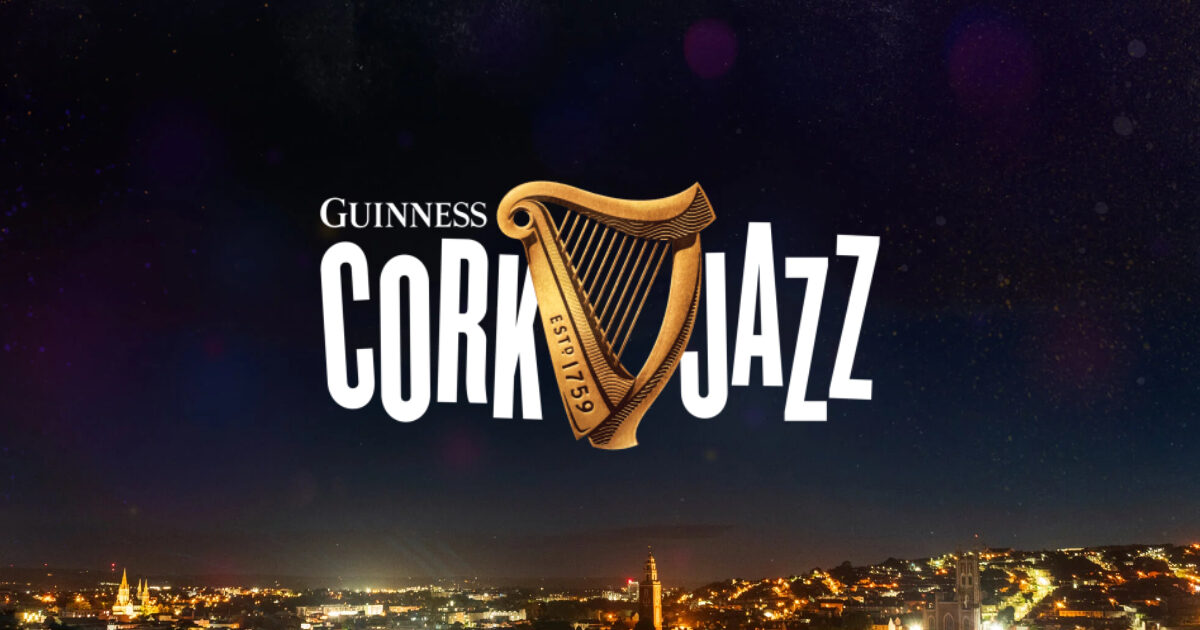 Guinness Cork Jazz Festival logo with a harp symbol over a nighttime cityscape background.