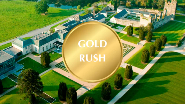 Aerial view of elegant hotel with lush gardens, historic architecture, and tranquil landscape, offering a luxurious stay.