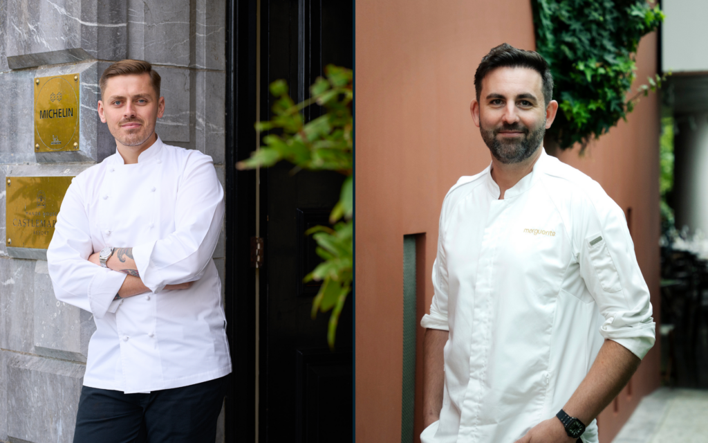 Two chefs in crisp, white jackets stand outside, reflecting the hotel's gourmet dining experience and Michelin recognition.