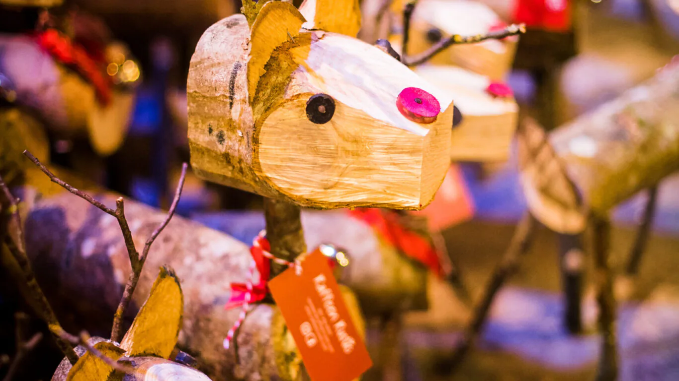 Charming handcrafted wooden reindeer with twig antlers adorn the hotel lobby, adding festive cheer and warmth for guests.