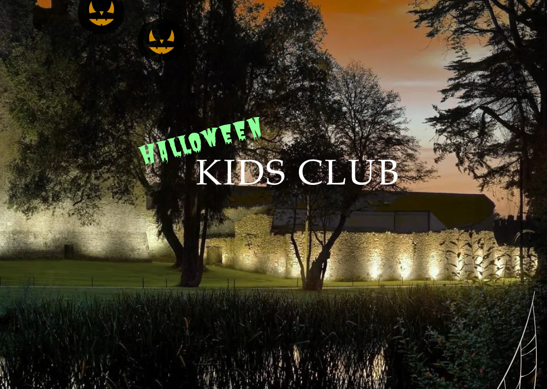 Enchanting Halloween kids club by a serene lake, with illuminated castle walls and festive decorations at sunset.